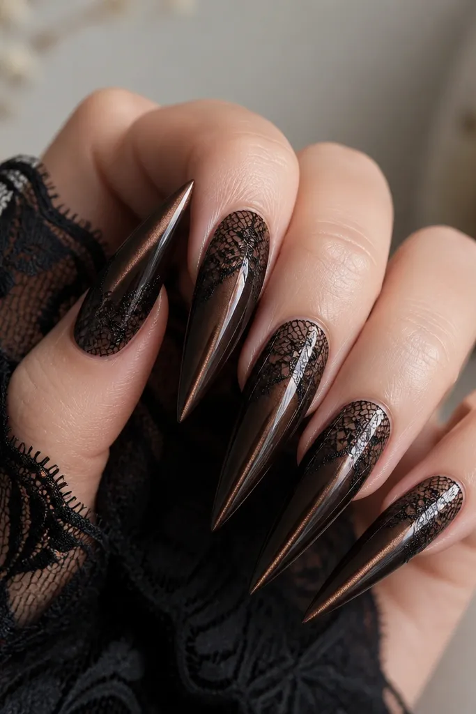 Long stiletto nails in dark brown cat eye with a centered stripe. Over the top half, there is black lace decal detail that looks like a delicate net pattern, all under glossy topcoat.