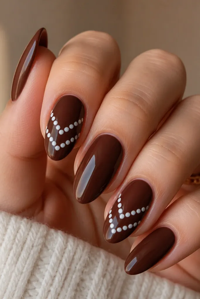 A vintage warm brown base with a white chevron made of small polka dots. The chevron points upward toward the tip, with crisp lines and glossy shine.