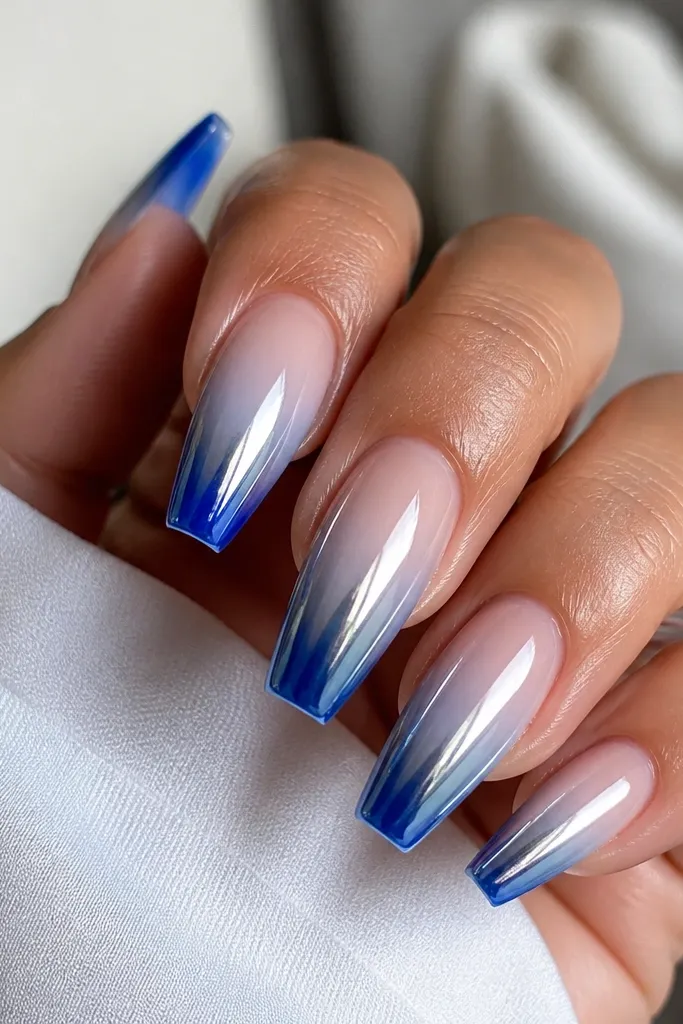 Medium coffin nails with cobalt blue at the tips fading into clear-to-baby blue; silver chrome highlights the center and tip.