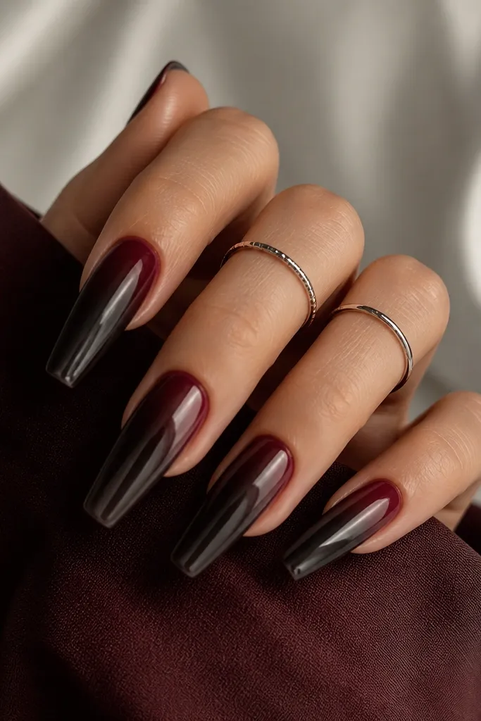 Coffin nails with black cherry ombre fading into dark wine; gunmetal chrome is applied like a thin veil over the mid-to-tip.