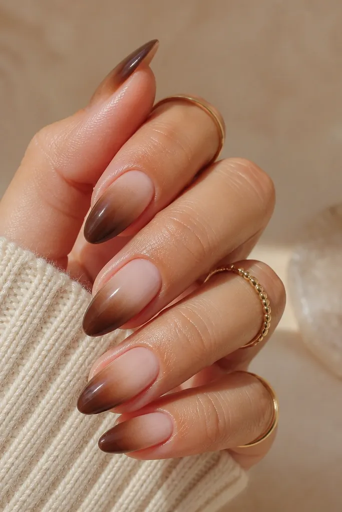 Short nails with a milky nude base. The tips fade into chocolate brown, with a soft transition and glossy finish.