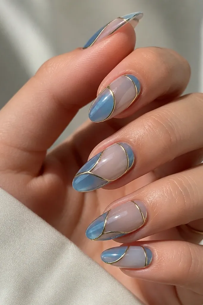 Nails have translucent blue panels separated by thin yellow lines, like stained glass. The base looks slightly sheer under the gel. Glossy finish.