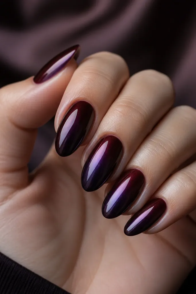 A dramatic ombre from black cherry at the cuticle to dark plum at the tips with a deep plum chrome that reflects a purple-black shine.