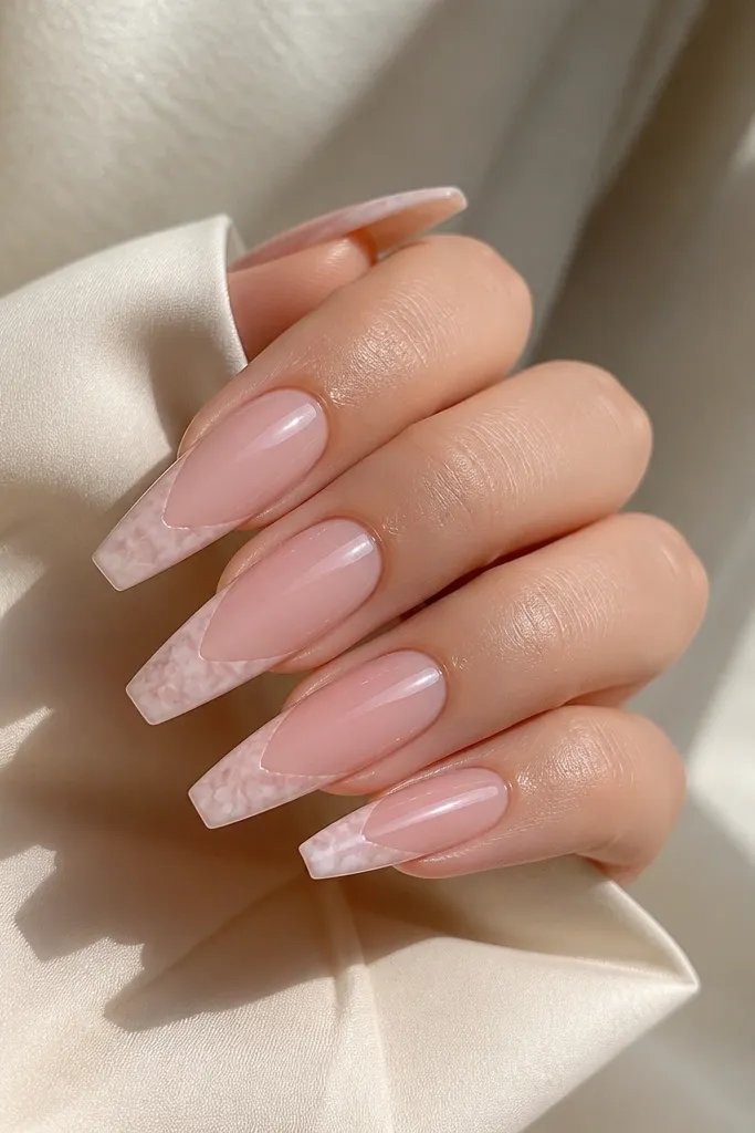 Coffin nails with translucent pink base; French tips are white-pink with cloudy rose quartz swirls; glossy finish.