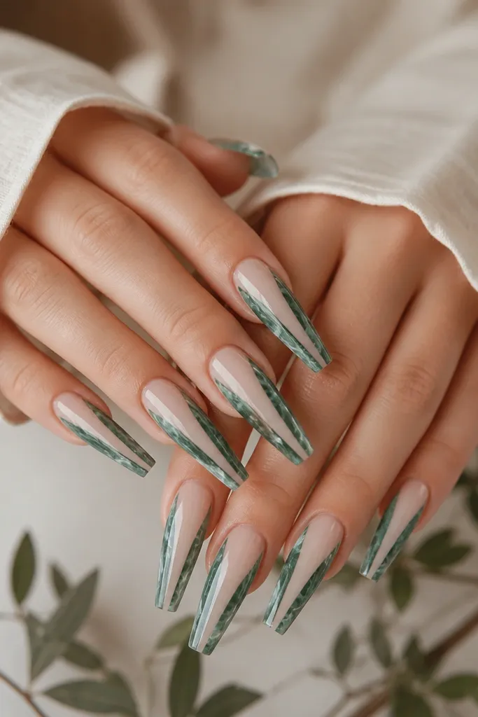 Coffin nails with forest green marble swirls on a mostly clear base. There are wispy white lines inside the marble, and a clean negative-space strip runs down the center of each nail.