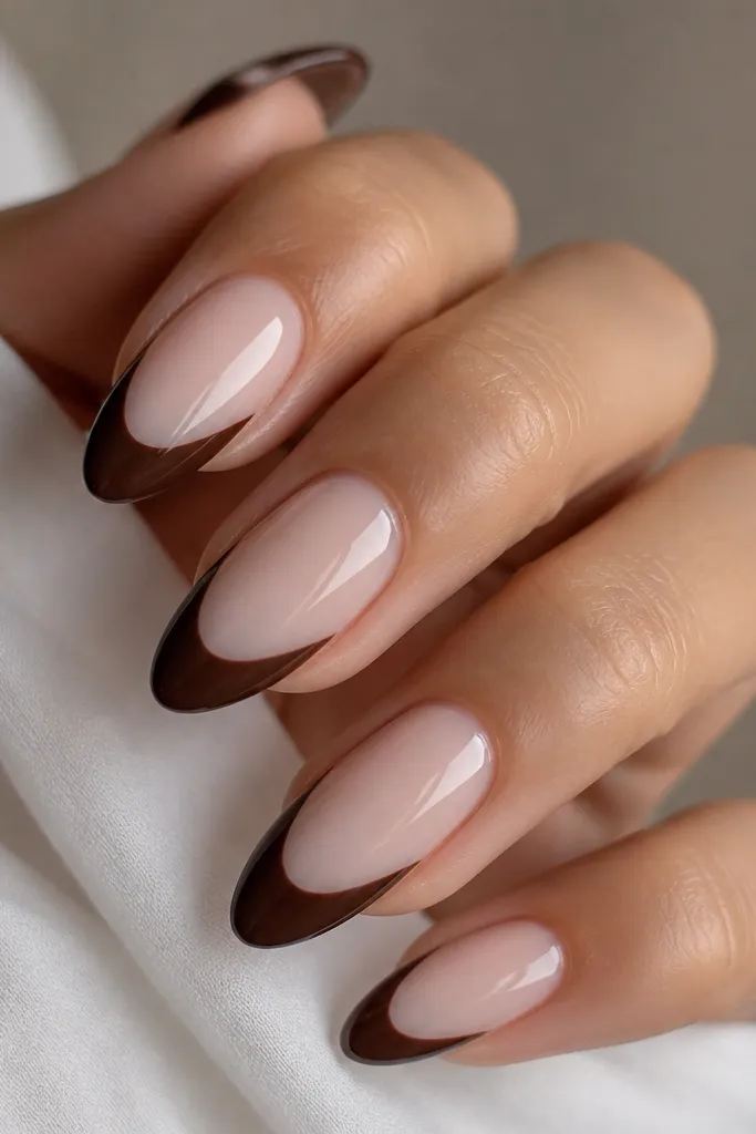 Milky nude nails with chocolate brown tips covering about the last third; glossy; clean straight-ish tip line.