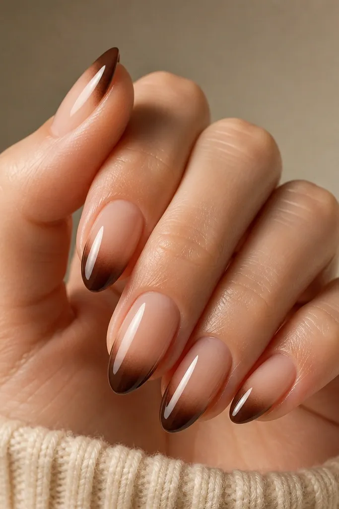Short square nails with a nude base. The tips are espresso brown but fade softly into the nude, creating a gradient French tip. The fade is smooth with no harsh line.