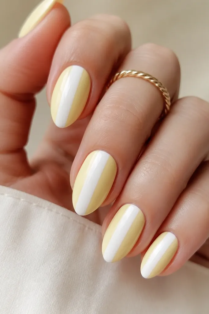 Each nail has a light yellow base with one or two thin white stripes running vertically near the side. Stripes are straight and glossy.