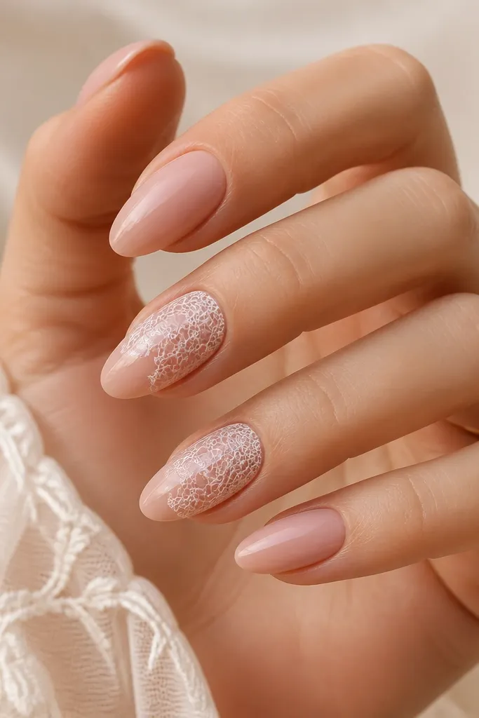 Short oval nails with sheer nude base. Thin white lace-like lines form a vertical panel down the center of each nail, glossy finish.