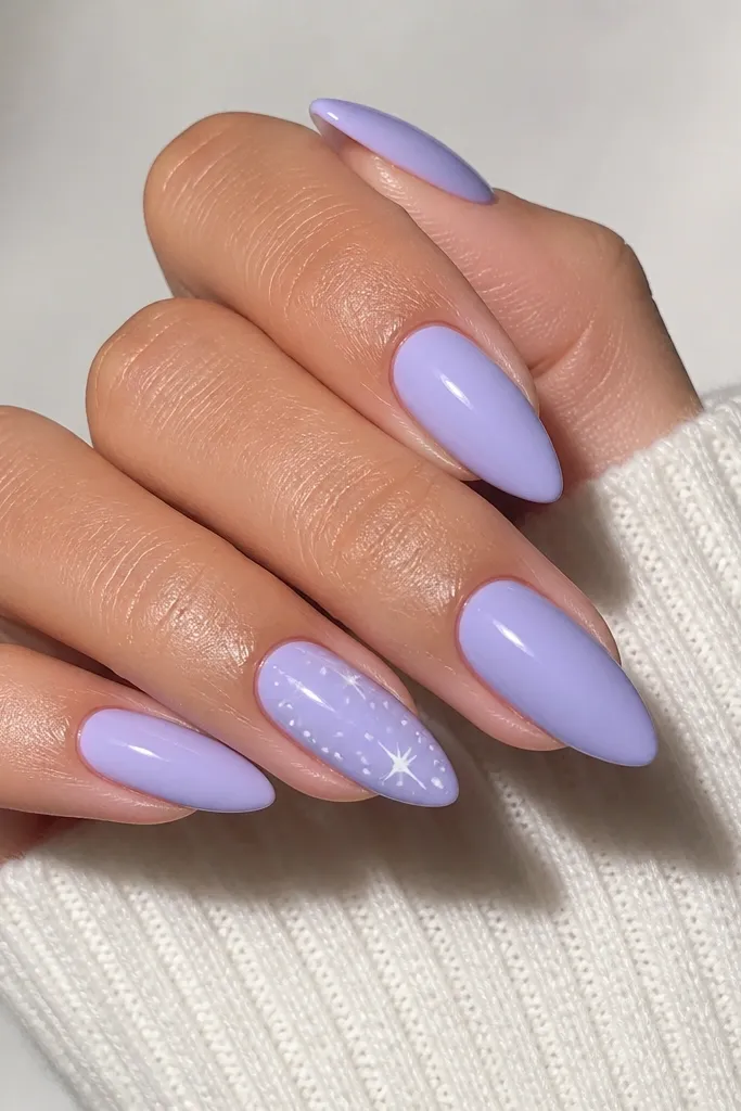 Short stiletto nails painted icy lavender. On two nails, there are tiny white star dots scattered near the tip, with a glossy finish and clean cuticle lines.