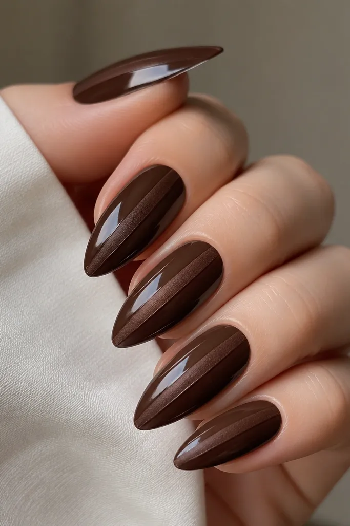 Espresso brown cat eye nails with a single thin velvet-brown line drawn down the center, creating a matte texture line over glossy base.